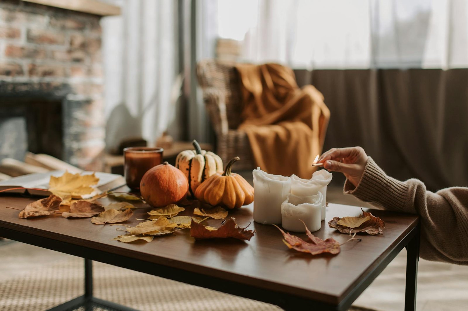 a person lighting candles on a coffee table