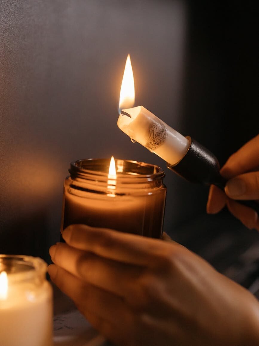 close up shot of a person lighting the candles